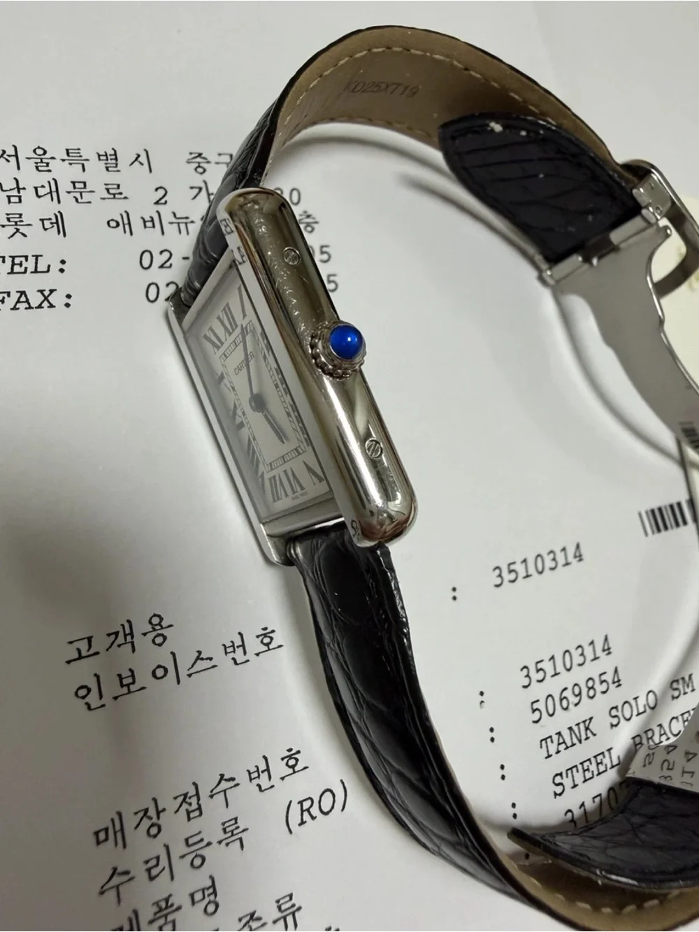 Cartier Tank Watch with Silver Case and Black Leather Strap